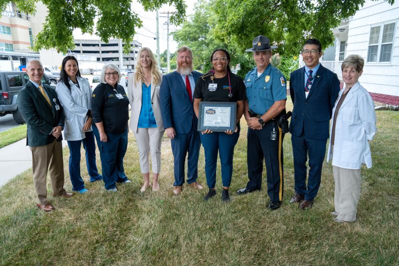 Beebe and Millsboro representatives gathered are (l-r) R.L. Hughes; Teri Wilkinson, RN; Susan Mross, RN; Ashley Foster, chief people officer; Town Manager Jamie Burk; honoree Jalissa Jones; Chief Brian Calloway; Dr. David Tam, Beebe president and CEO; and Kathy Tregear, chief nursing executive. SUBMITTED PHOTO